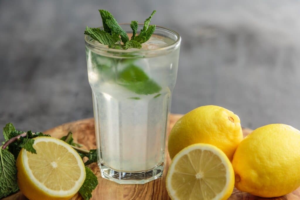 lime juice on drinking glass beside sliced limes - angrylionfitness.com