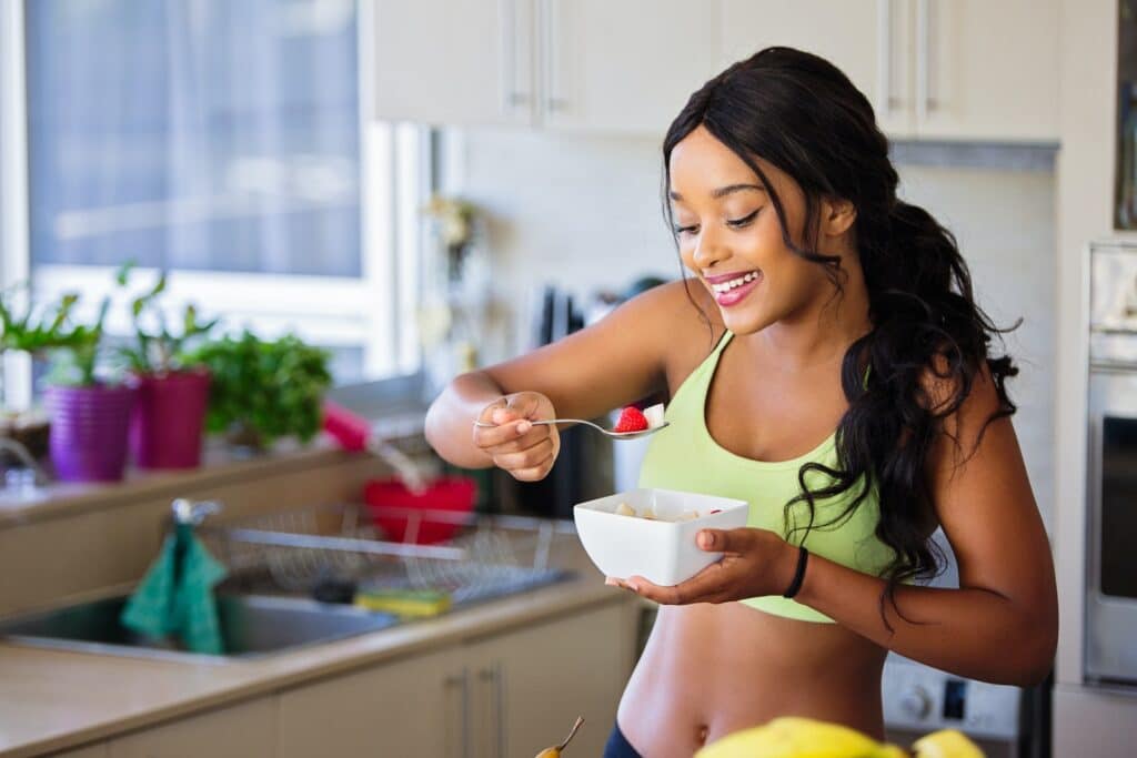 Woman Eating Strawberry in the Kitchen 16/8 Intermittent Fasting