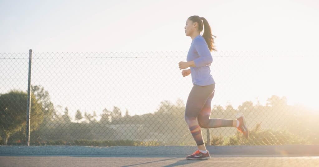 woman jogging near wire fence running