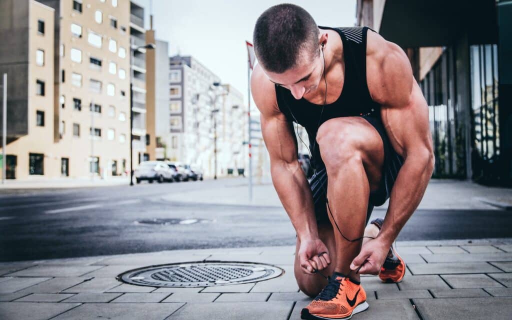 man tying his shoes running