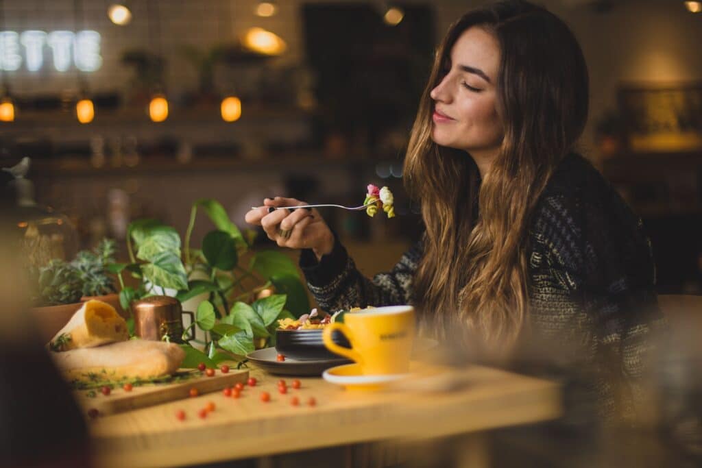 woman holding fork in front table 16/8 Intermittent Fasting