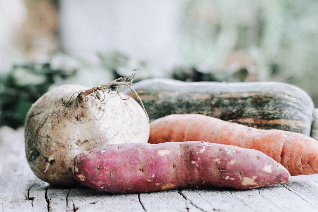 orange carrots on brown wooden table Root Vegetables