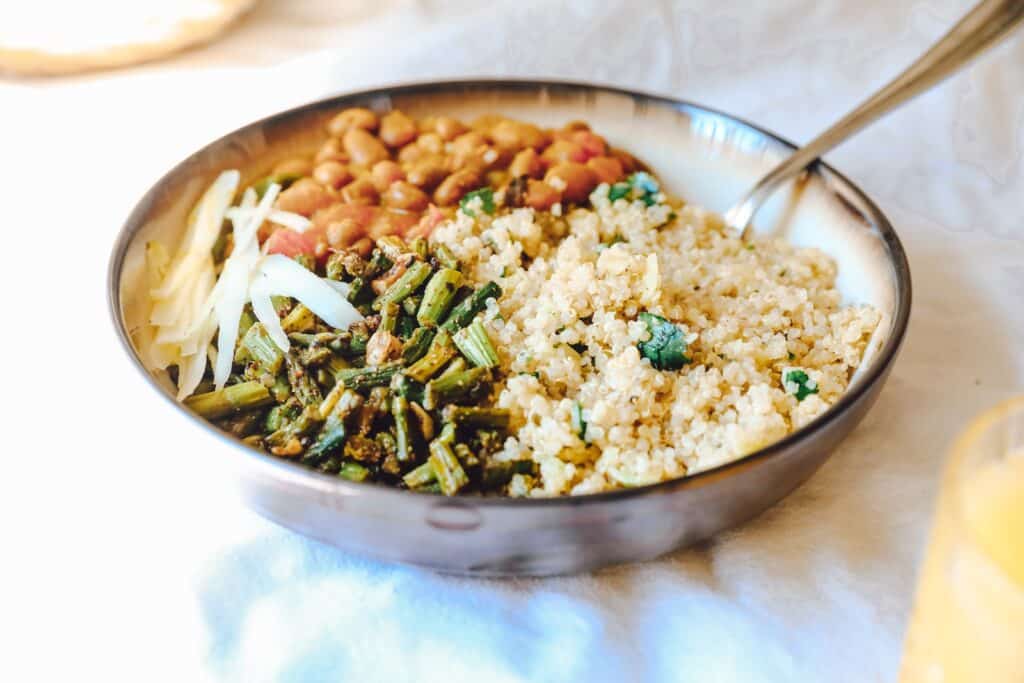 cooked rice with green peas and carrots on stainless steel bowl Quinoa