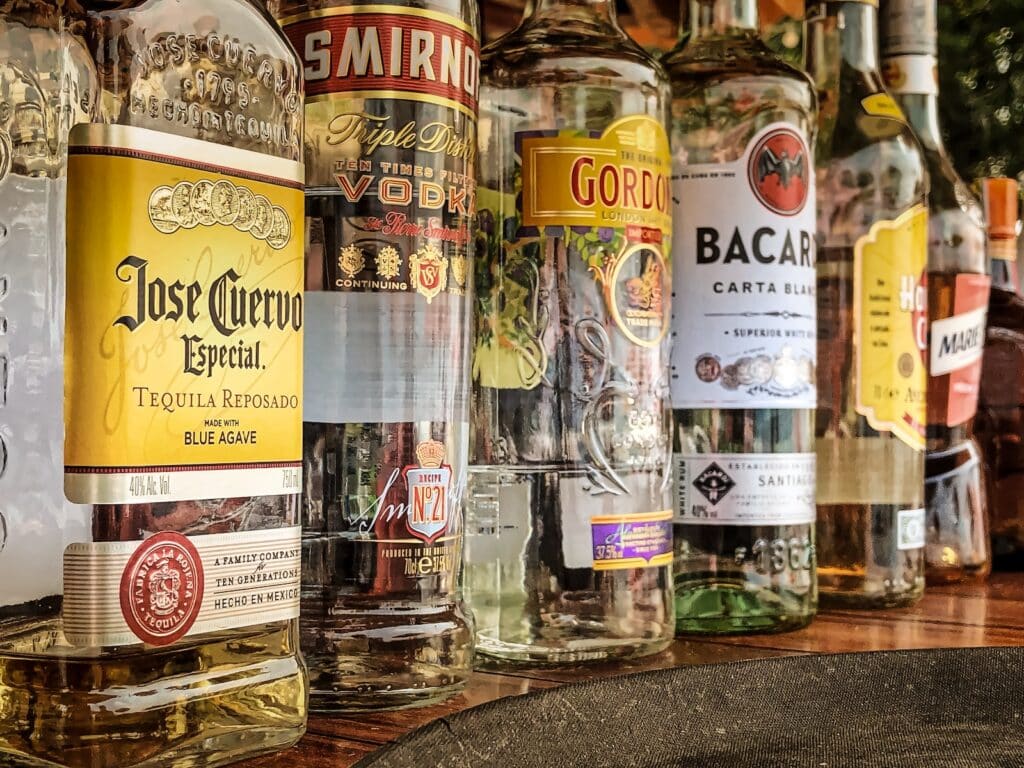 clear glass bottles on gray concrete floor Alcohol