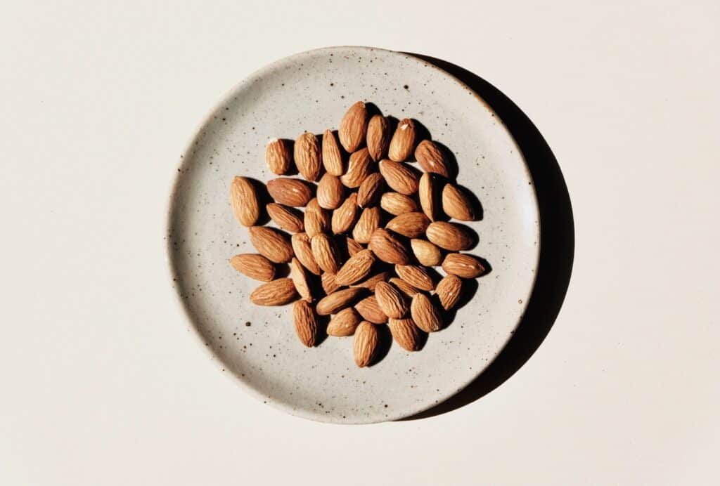 brown coffee beans on white ceramic bowl