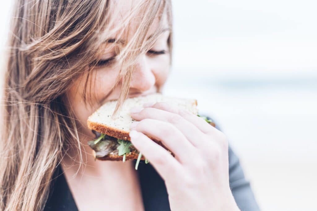 woman eating sandwich Mindful Eating