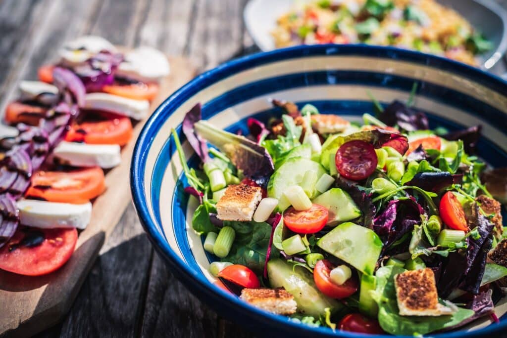 leafy vegetable dish in blue ceramic bowl Mediterranean diet