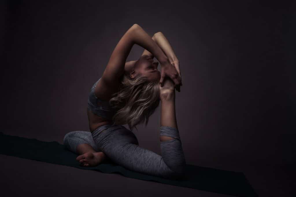 woman in blue denim jeans lying on black floor Stretching and Flexibility