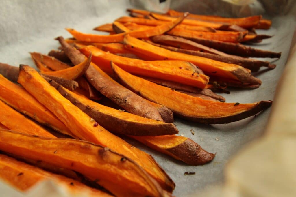 Sweet Potatoes sliced orange fruit on white table