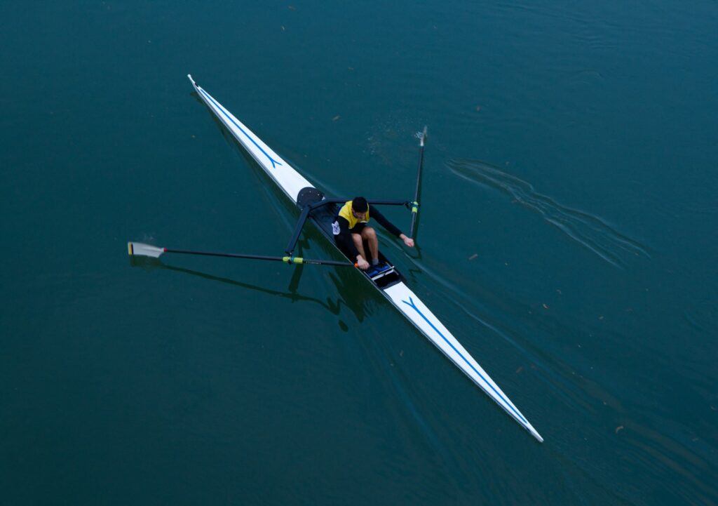 a person rowing a boat on a body of water